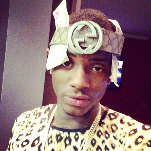 Rapper soulja boy wearing his gucci belt around his head